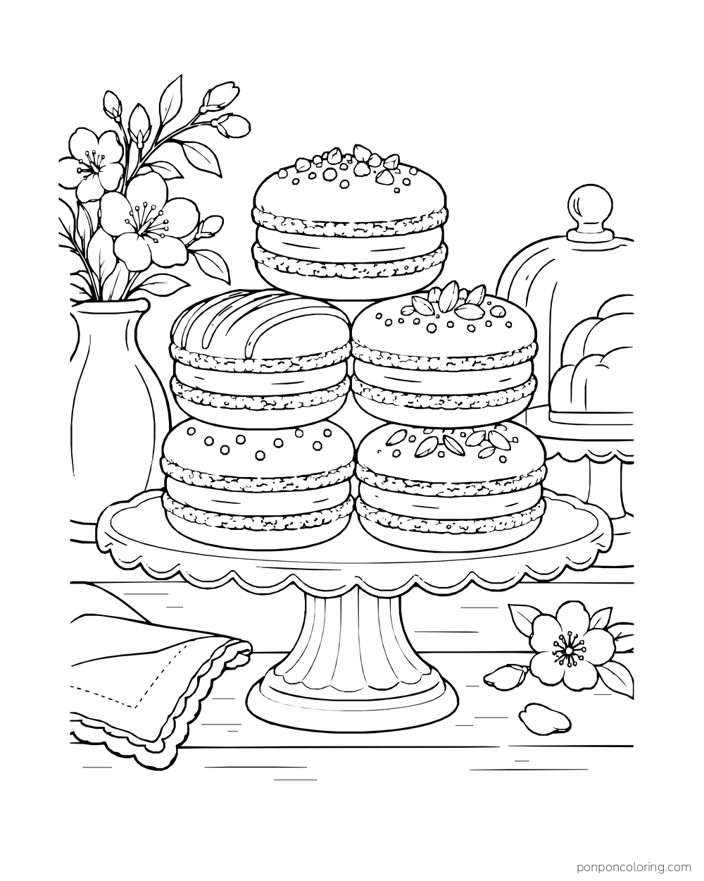 A stack of filled macarons stands on a cake plate beside flowers and a folded napkin.