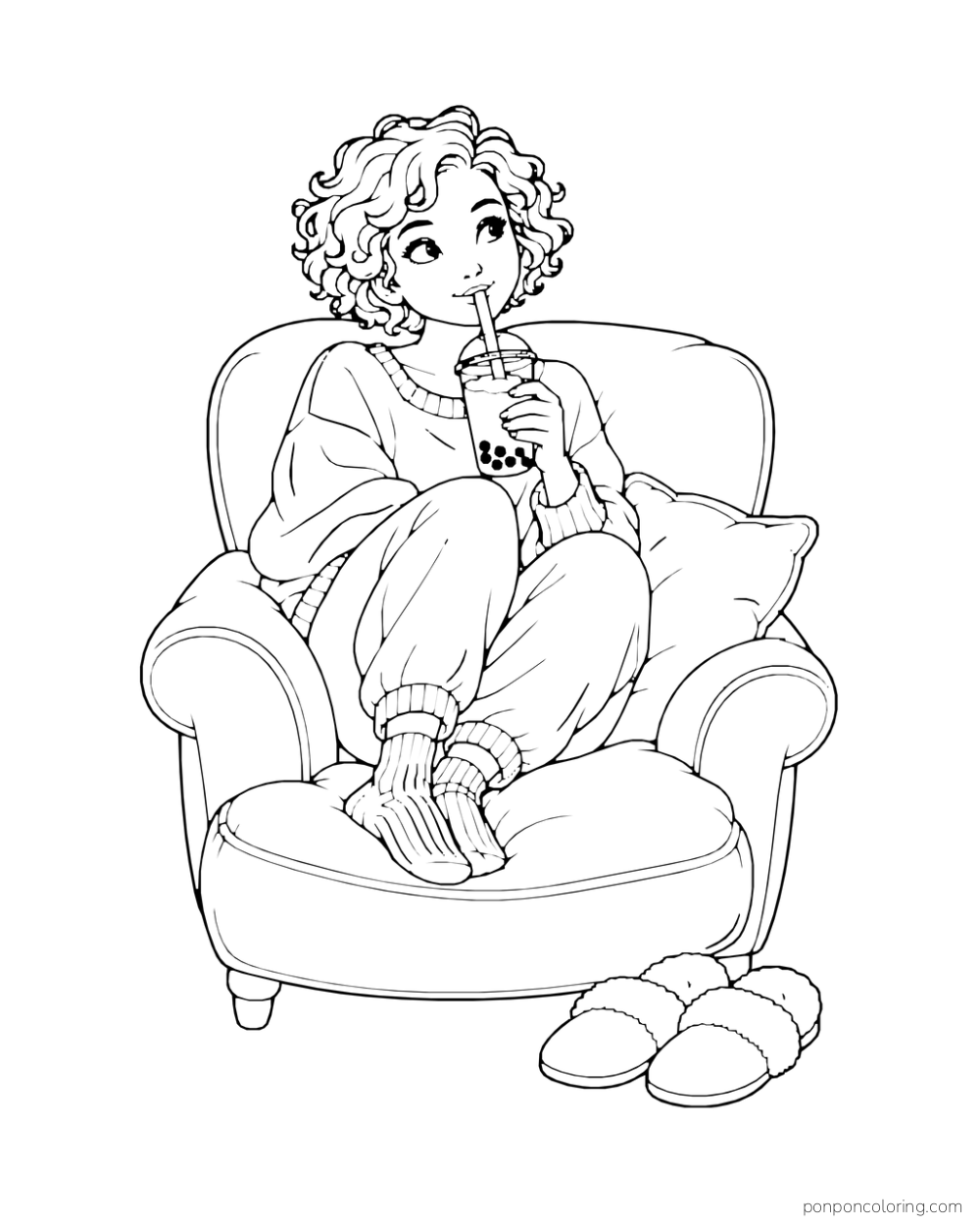 A person with curly hair sips boba in an armchair, with slippers on the floor.