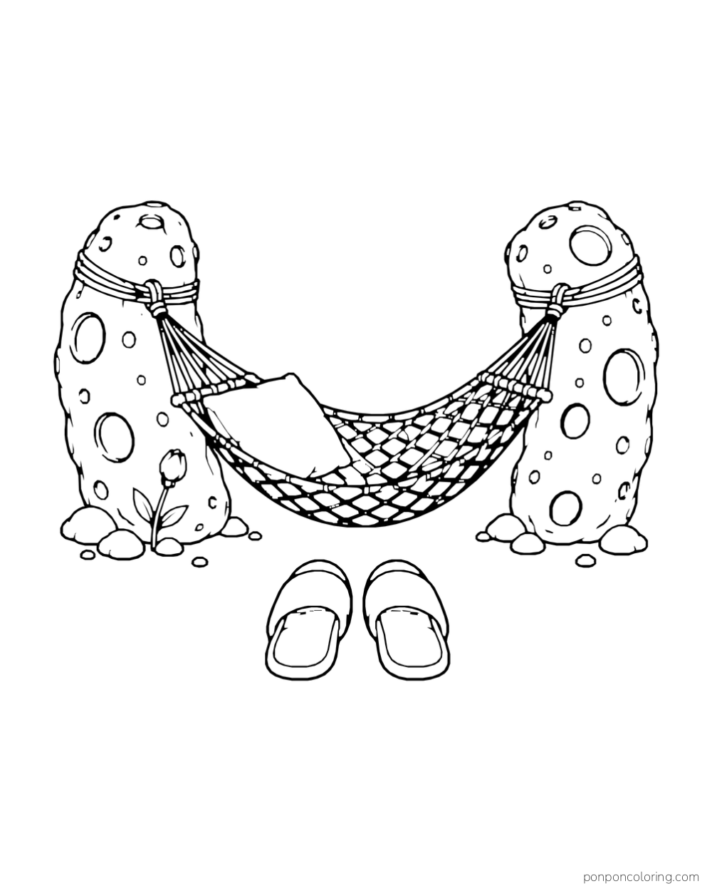 A hammock hangs between moon rocks with slippers placed below it.