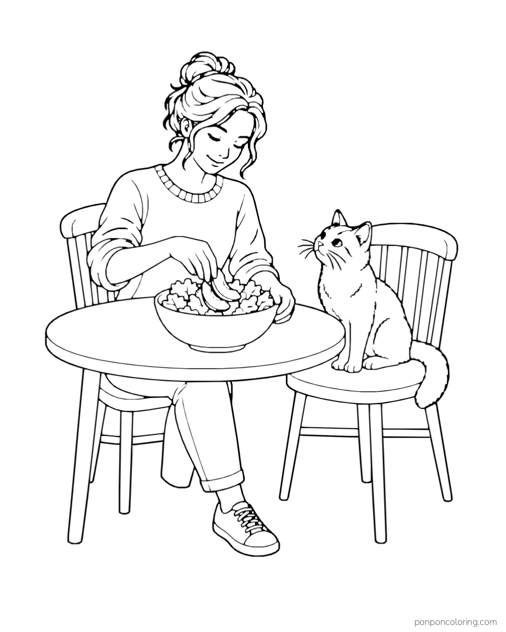 An adult adds avocado slices to a salad at a table while a cat watches from a chair.