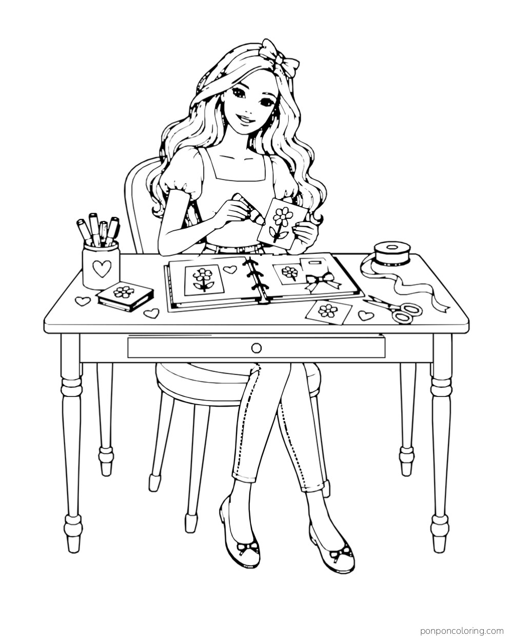 Barbie adds a flower picture to a scrapbook at a table with scissors, ribbon and drawing supplies.