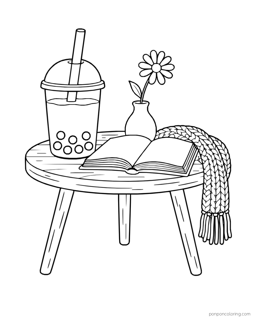 A boba tea cup, open book, daisy in a vase, and knitted scarf rest on a round three-legged table.