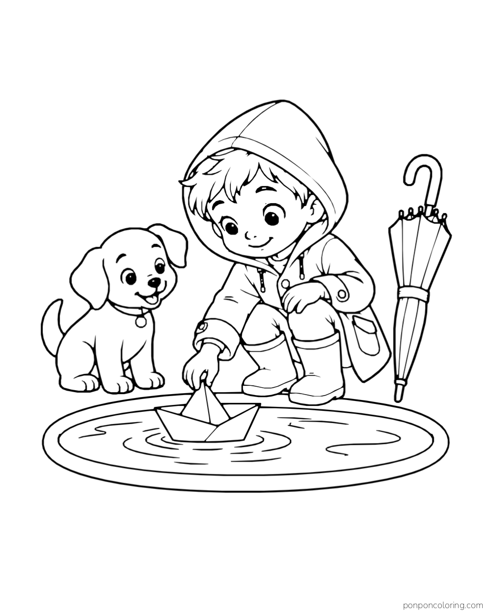 A boy in a raincoat floats a paper boat in a puddle beside a puppy and folded umbrella.