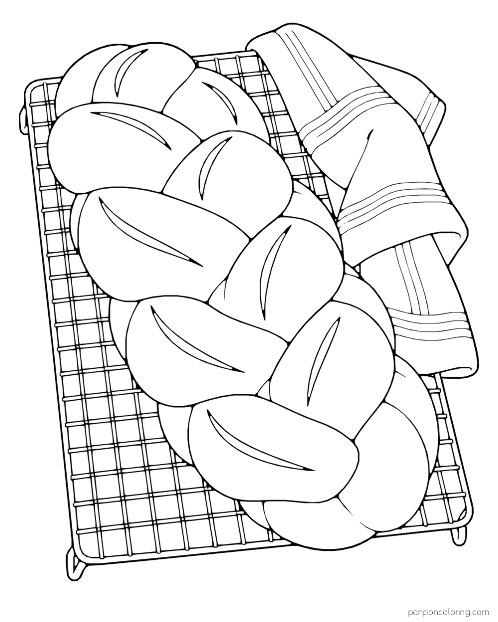 A large braided loaf cools on a wire rack beside a folded kitchen cloth.