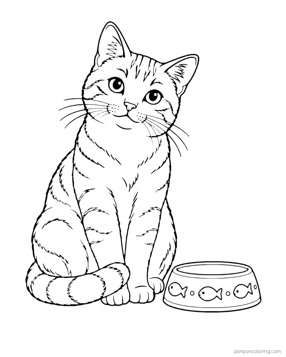 A tabby cat sits with its tail curled around its paws beside a bowl decorated with fish.