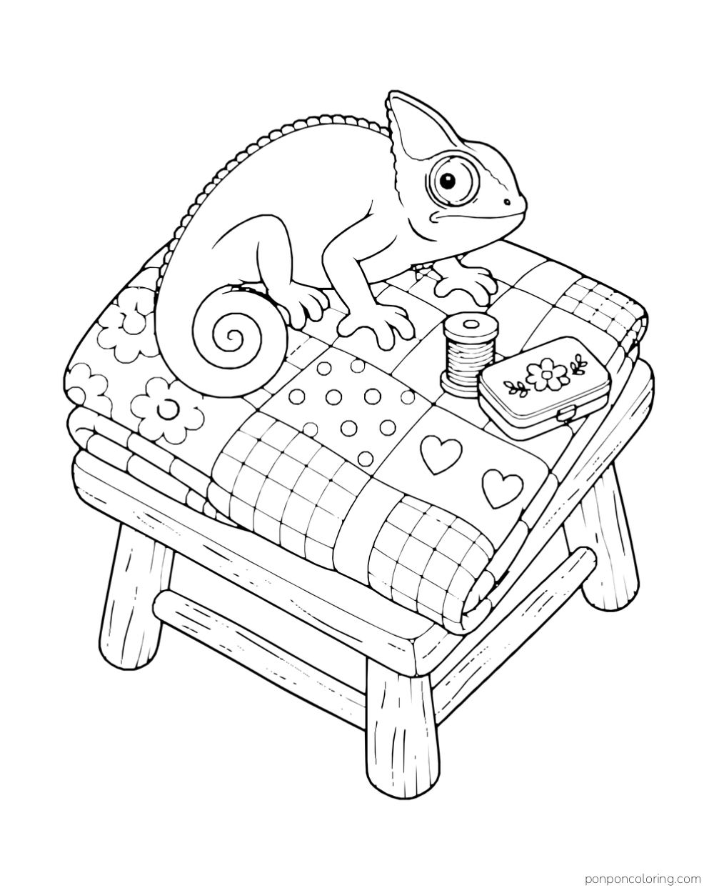 A chameleon curls on a folded patchwork quilt beside a thread spool and small case on a low stool.