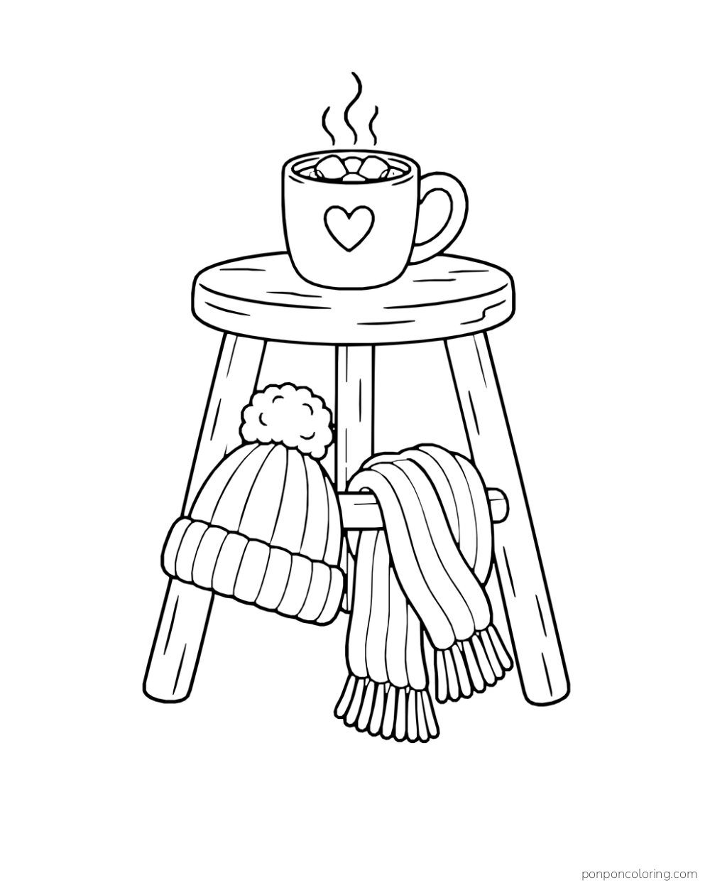 A cocoa mug sits on a three-legged stool above a wool hat and draped scarf.