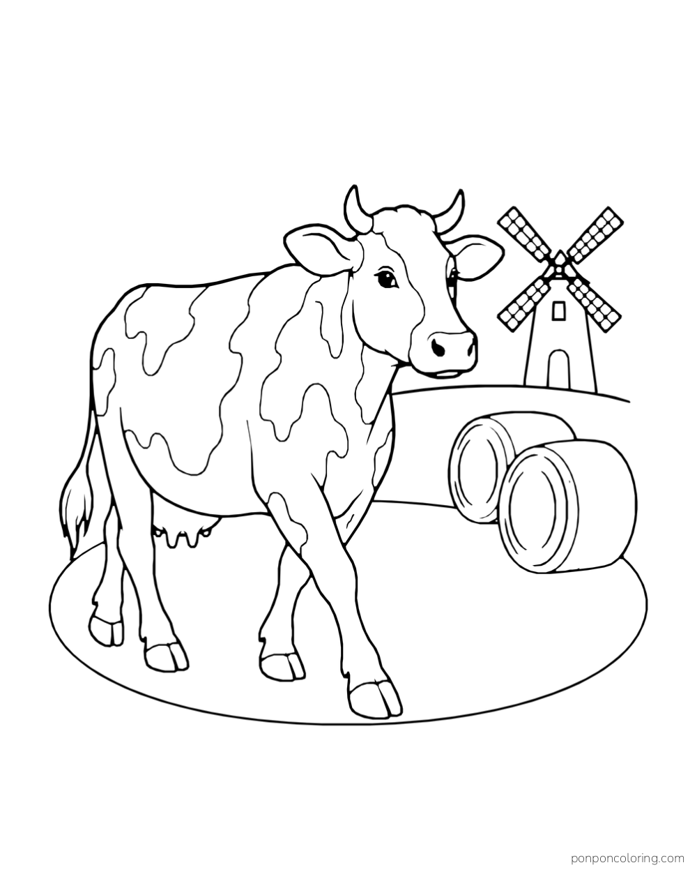 A cow walks past hay bales with a windmill in the distance.