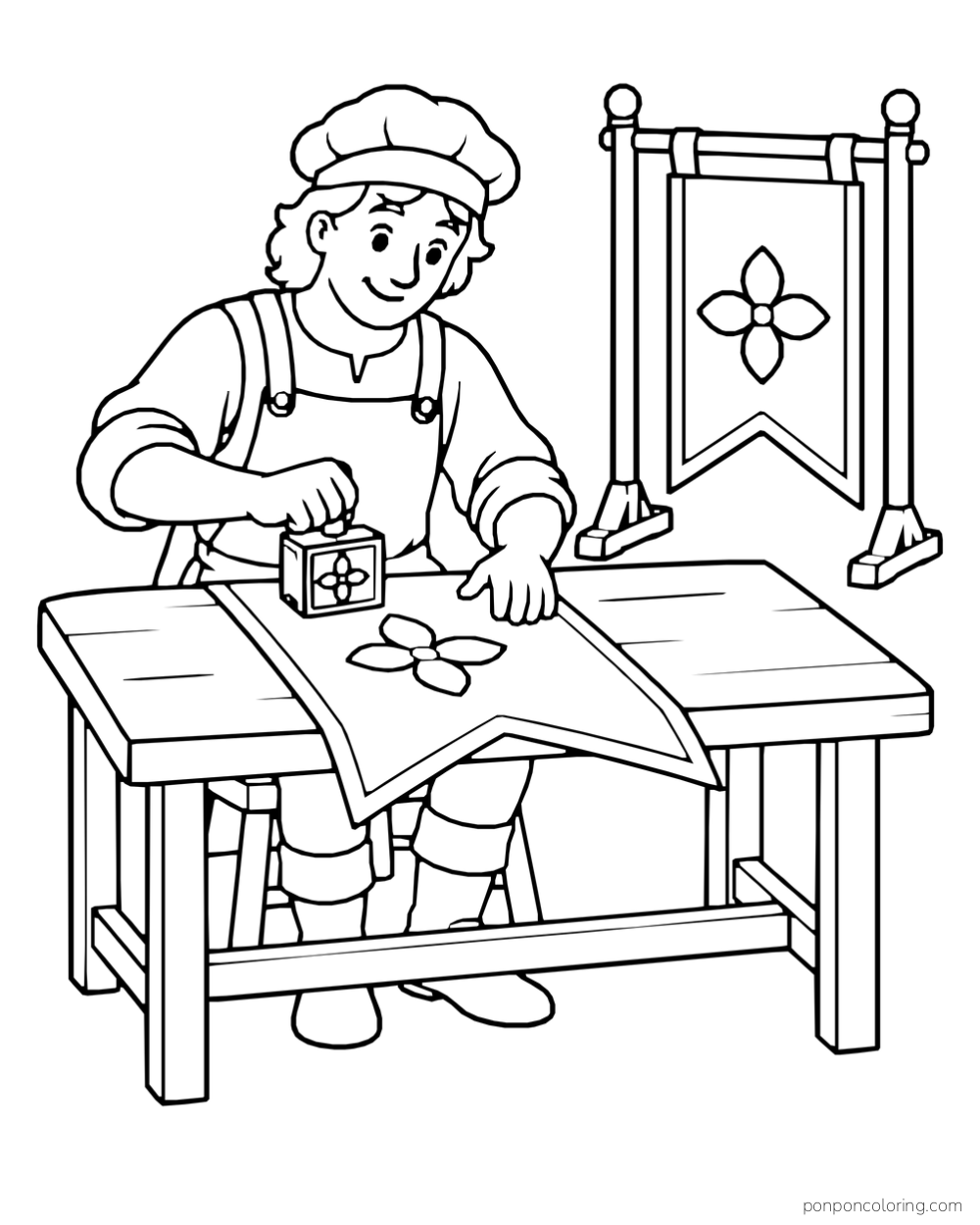 A craftsperson pressing a flower stamp onto a banner spread across a table, with a finished banner hanging behind.