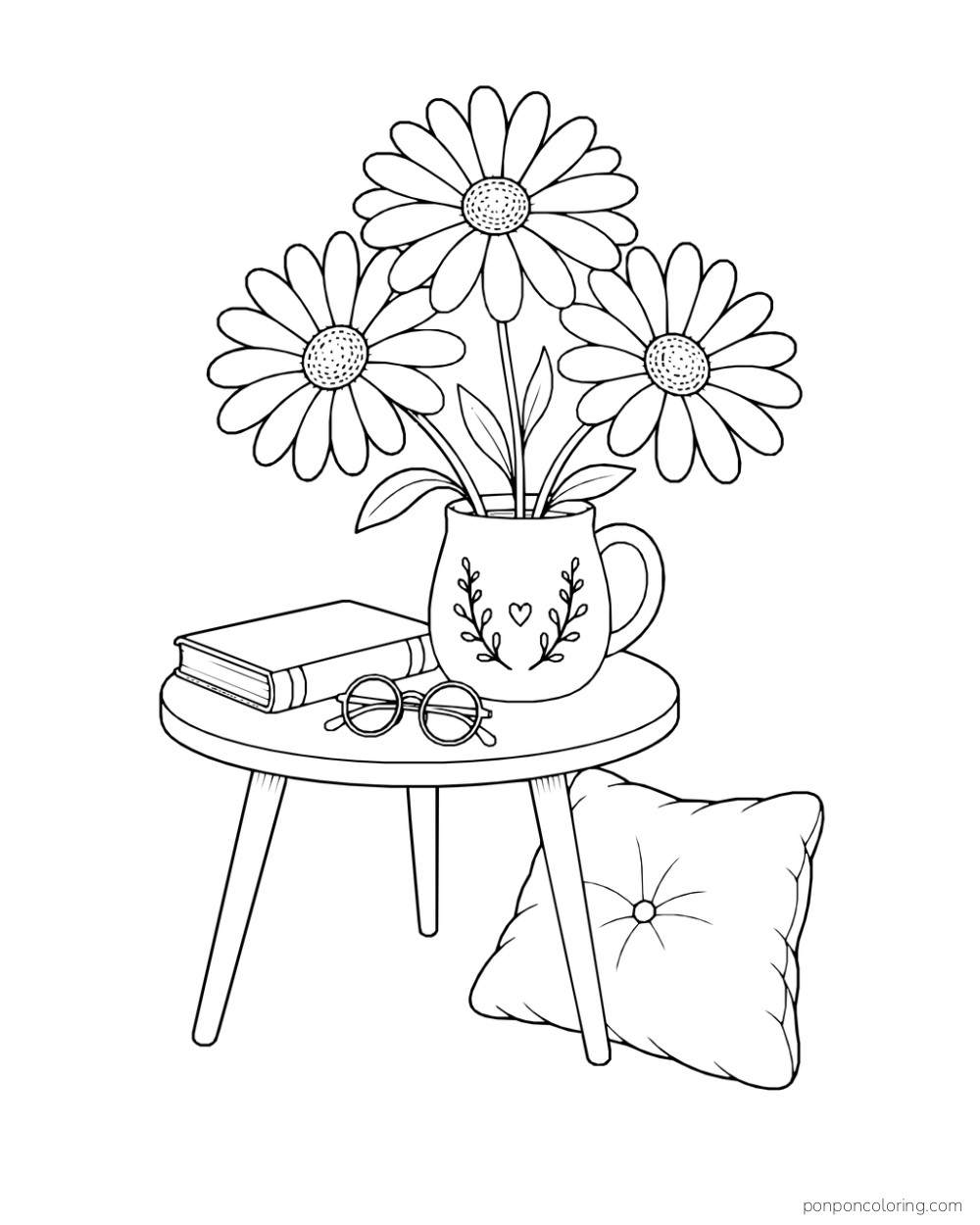 Three daisies in a decorated mug on a round table beside a closed book and glasses, with a tufted cushion leaning against one table leg.