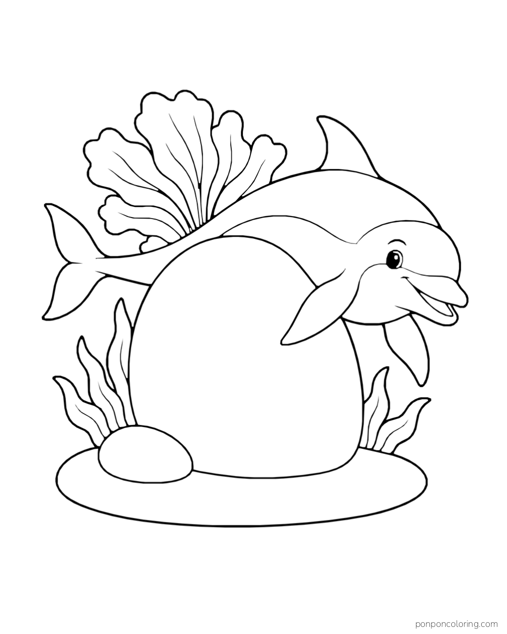 A dolphin curves around a smooth oval reef boulder with a fan-shaped sea plant behind it.