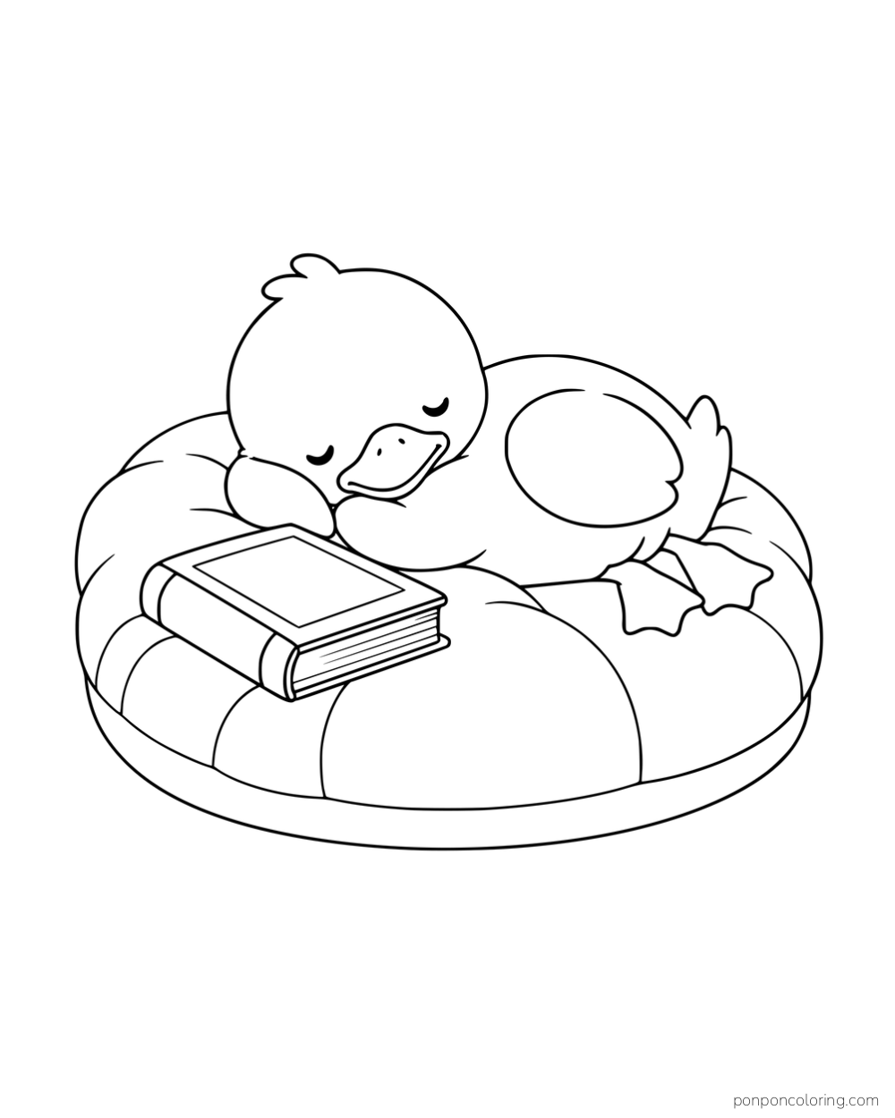 A sleeping duck resting on a large round cushion beside a closed book.