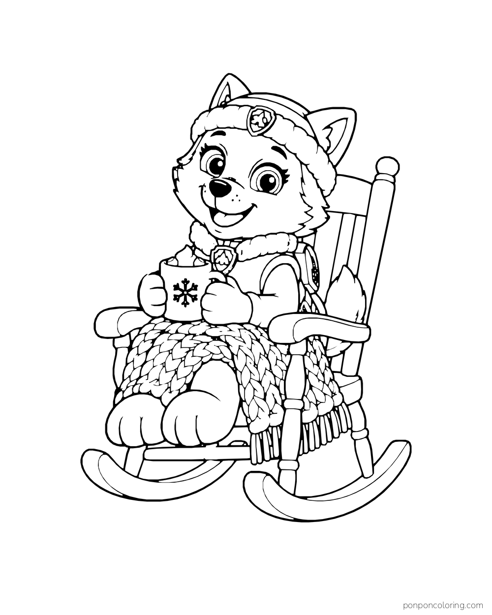 Everest holds a mug in a rocking chair with a knitted blanket over her lap.