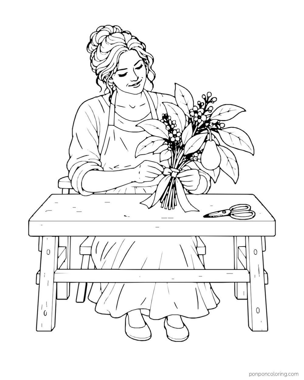 Adult florist ties a bouquet of avocado leaves, blossoms and one fruit.