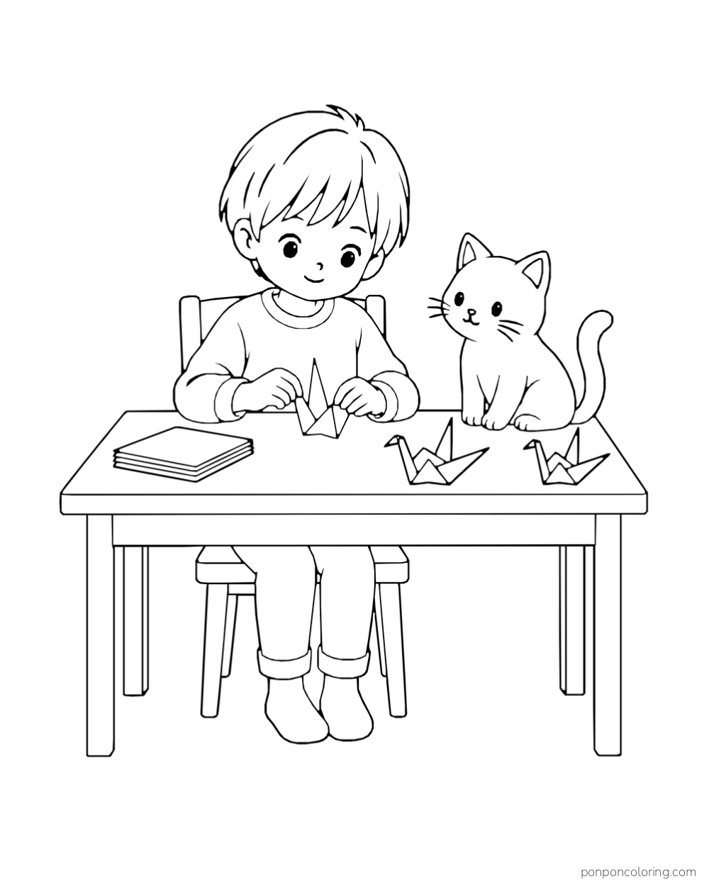 A boy folds paper cranes at a table while a cat watches.