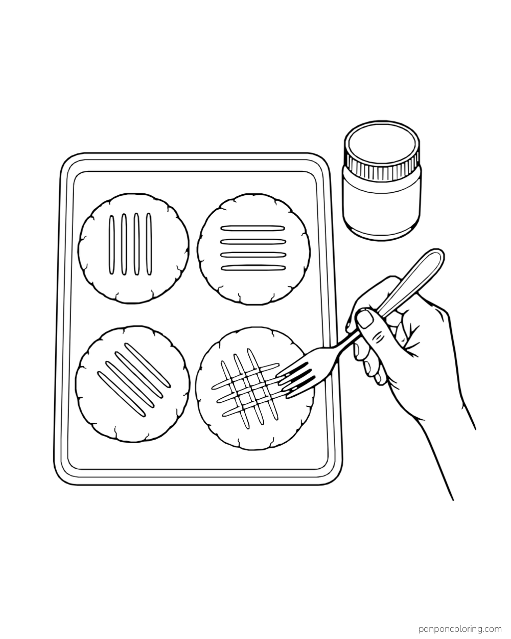 A hand makes fork marks in four round cookies on a baking sheet.