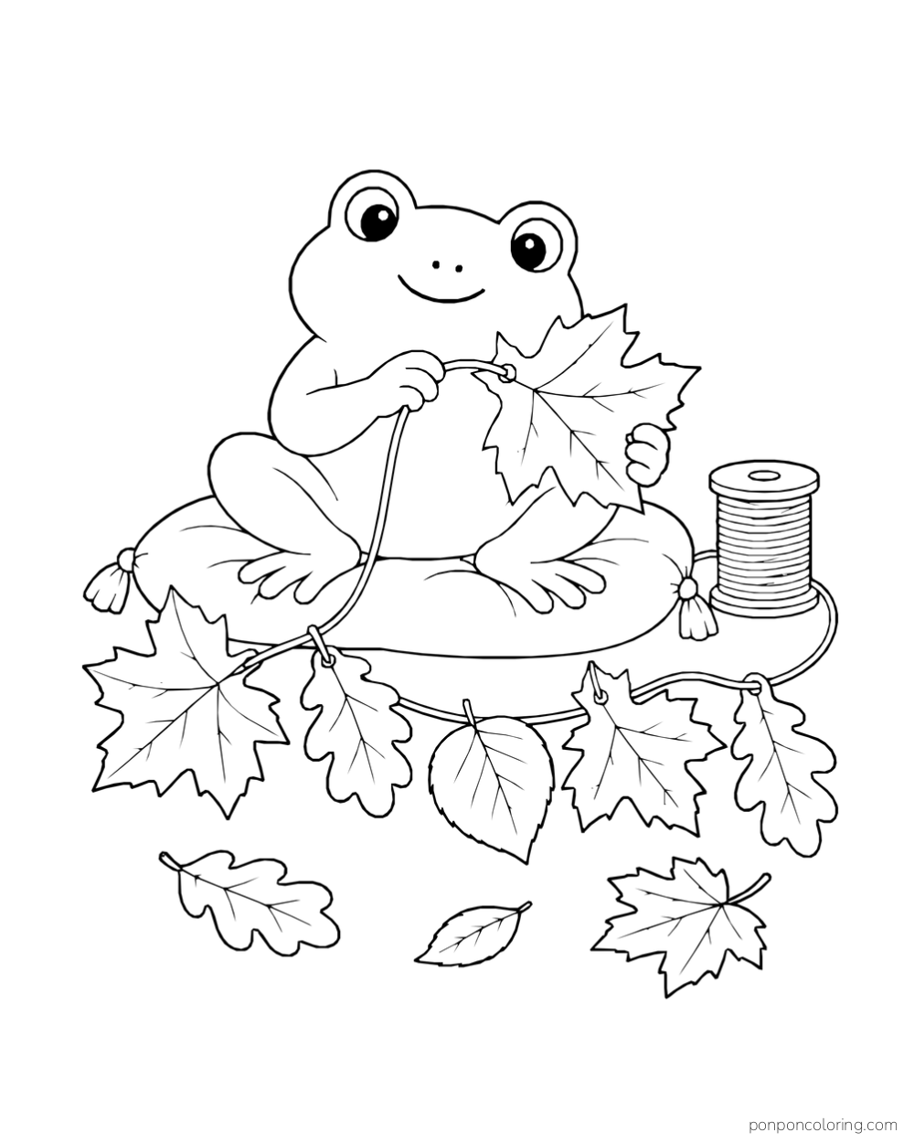 A frog sits on a cushion threading leaves onto a string beside a spool.