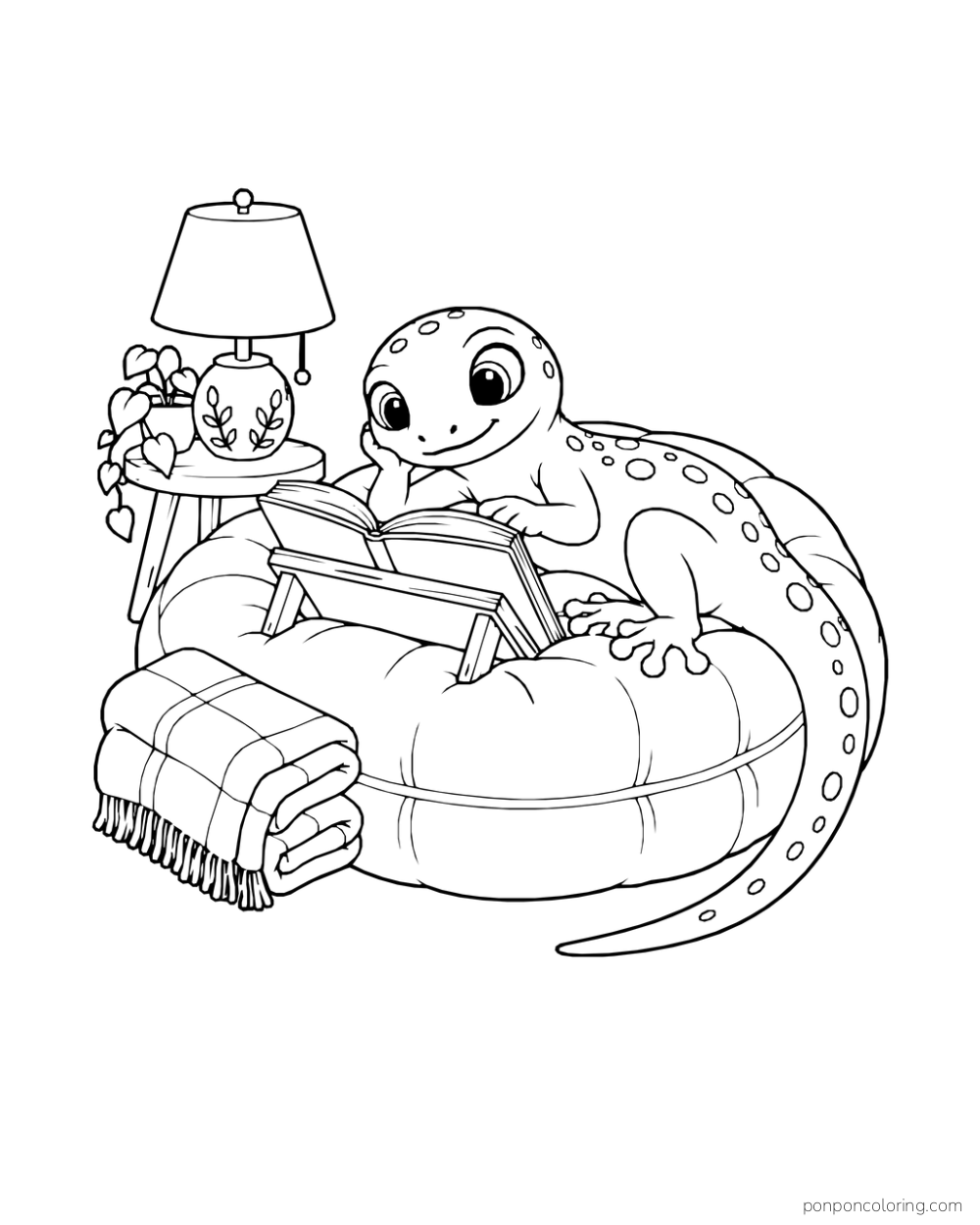 A gecko reading a book on a low stand while resting on a round cushion beside a lamp, potted plant, and folded blanket.