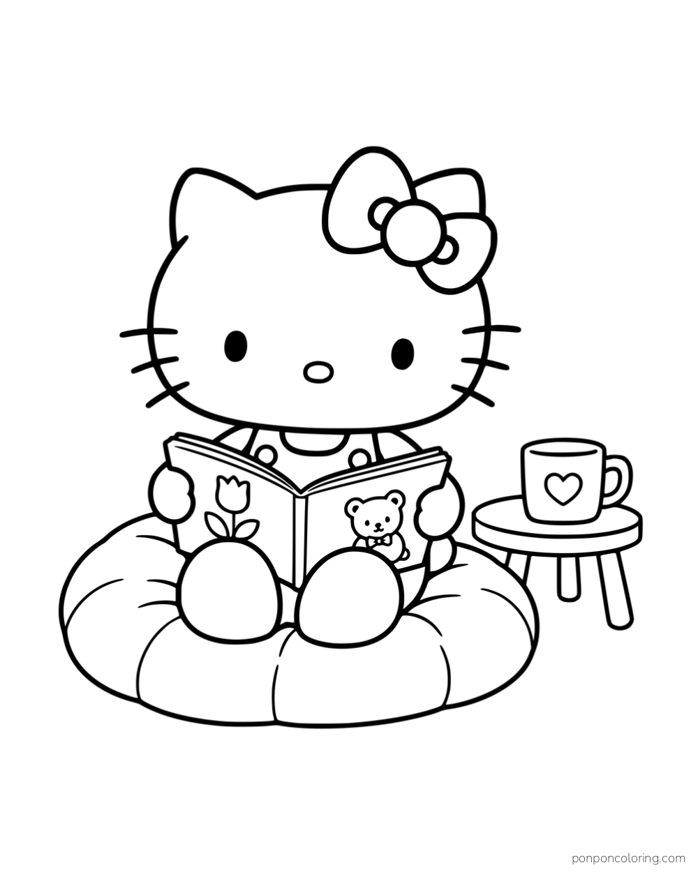 Hello Kitty reading a picture book on a round cushion beside a mug on a small table.