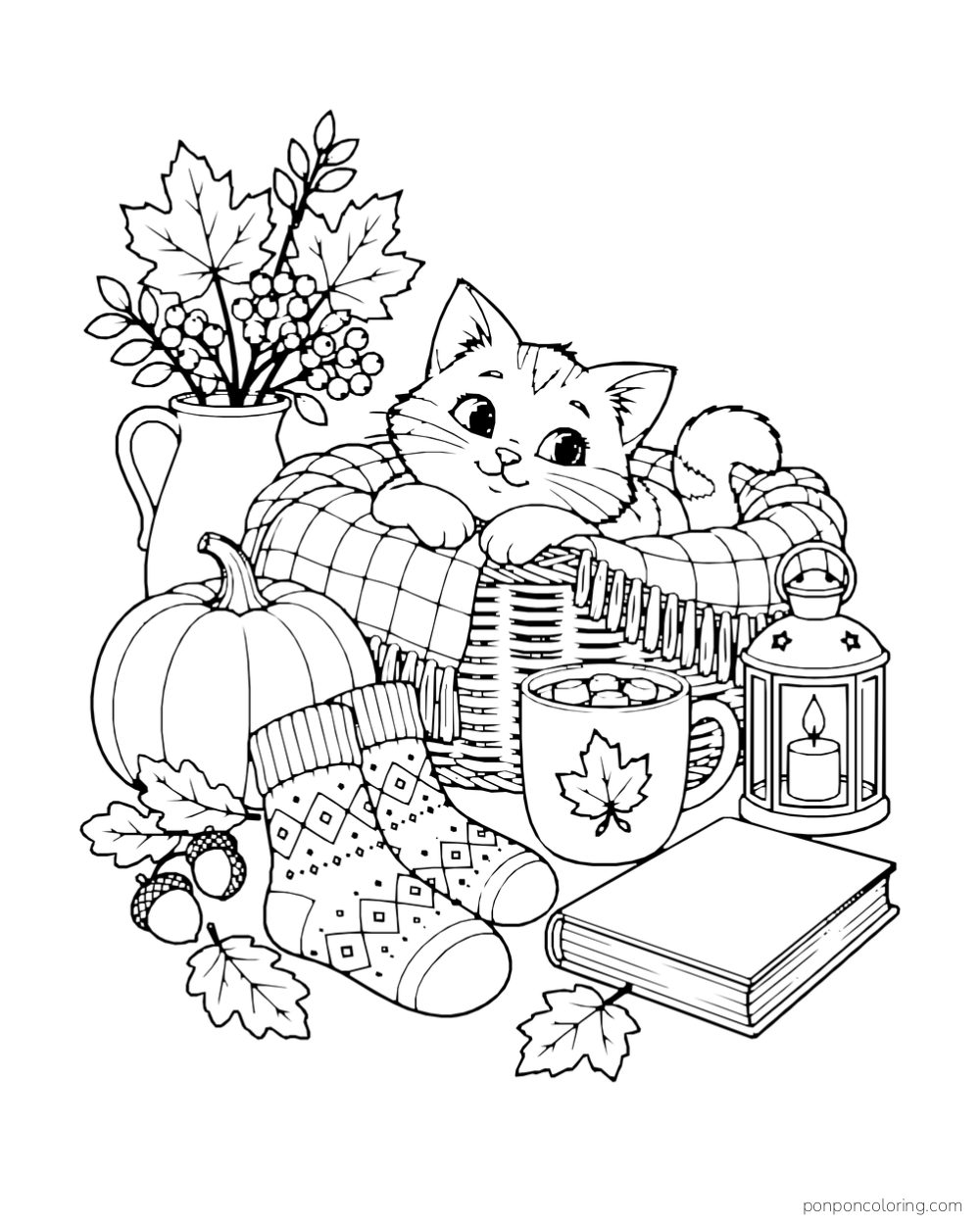 A kitten rests in a blanket basket beside patterned socks, a mug, a lantern, and a book.