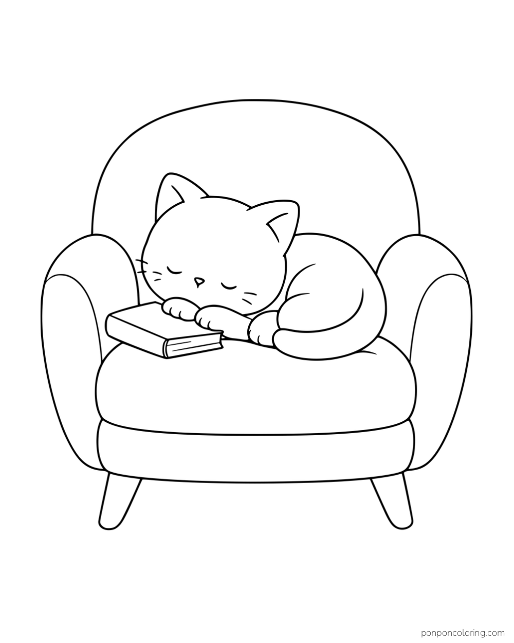 A kitten curled on an armchair with its paws resting on a closed book.