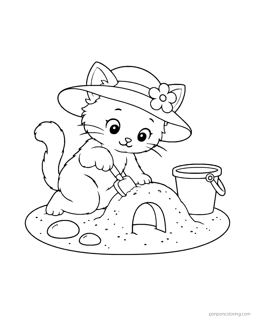 A kitten wearing a flowered sunhat digging a sand tunnel with a spade beside a bucket and two stones.