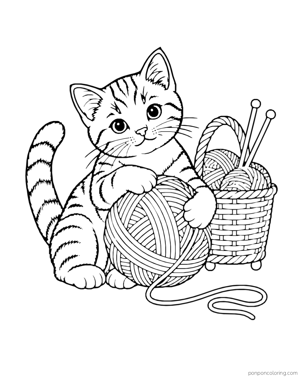 A tabby kitten hugs a large yarn ball beside a basket of yarn and two knitting needles.