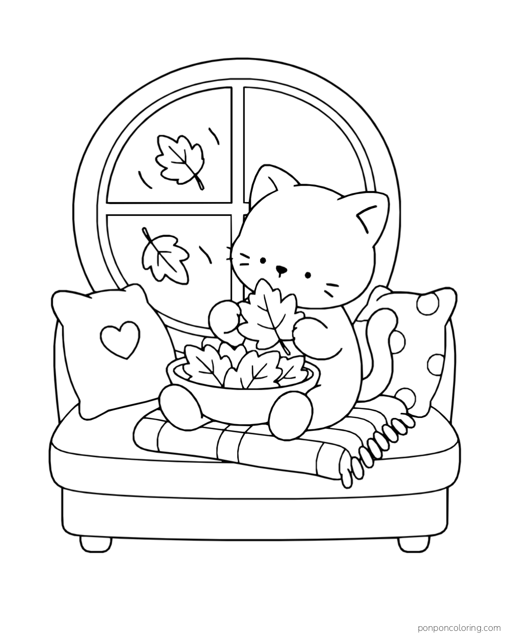 A kitten holding a leaf above a bowl of leaves on a cushioned window seat with pillows and a blanket.