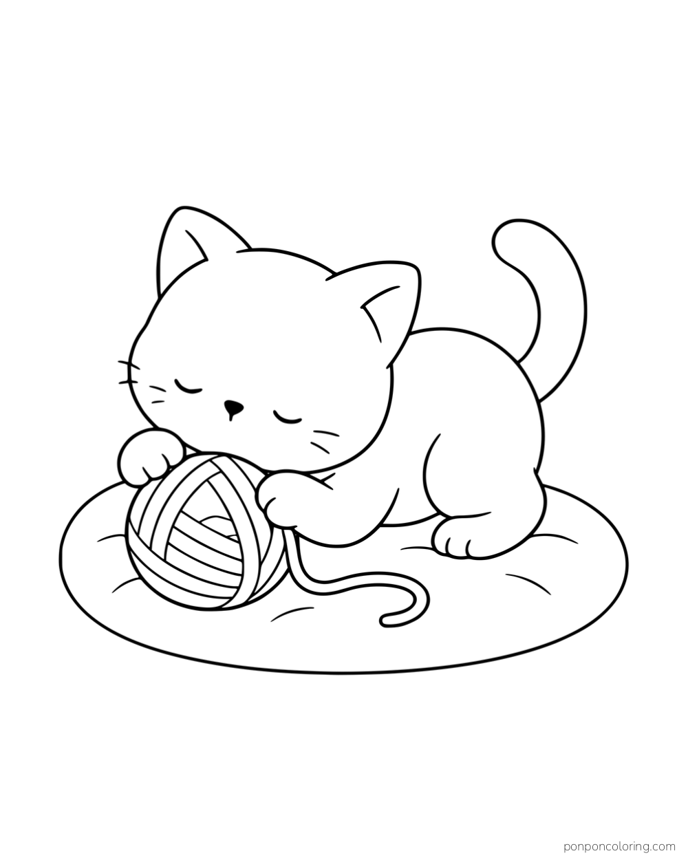 A kitten crouching over a ball of yarn on a small oval cushion.