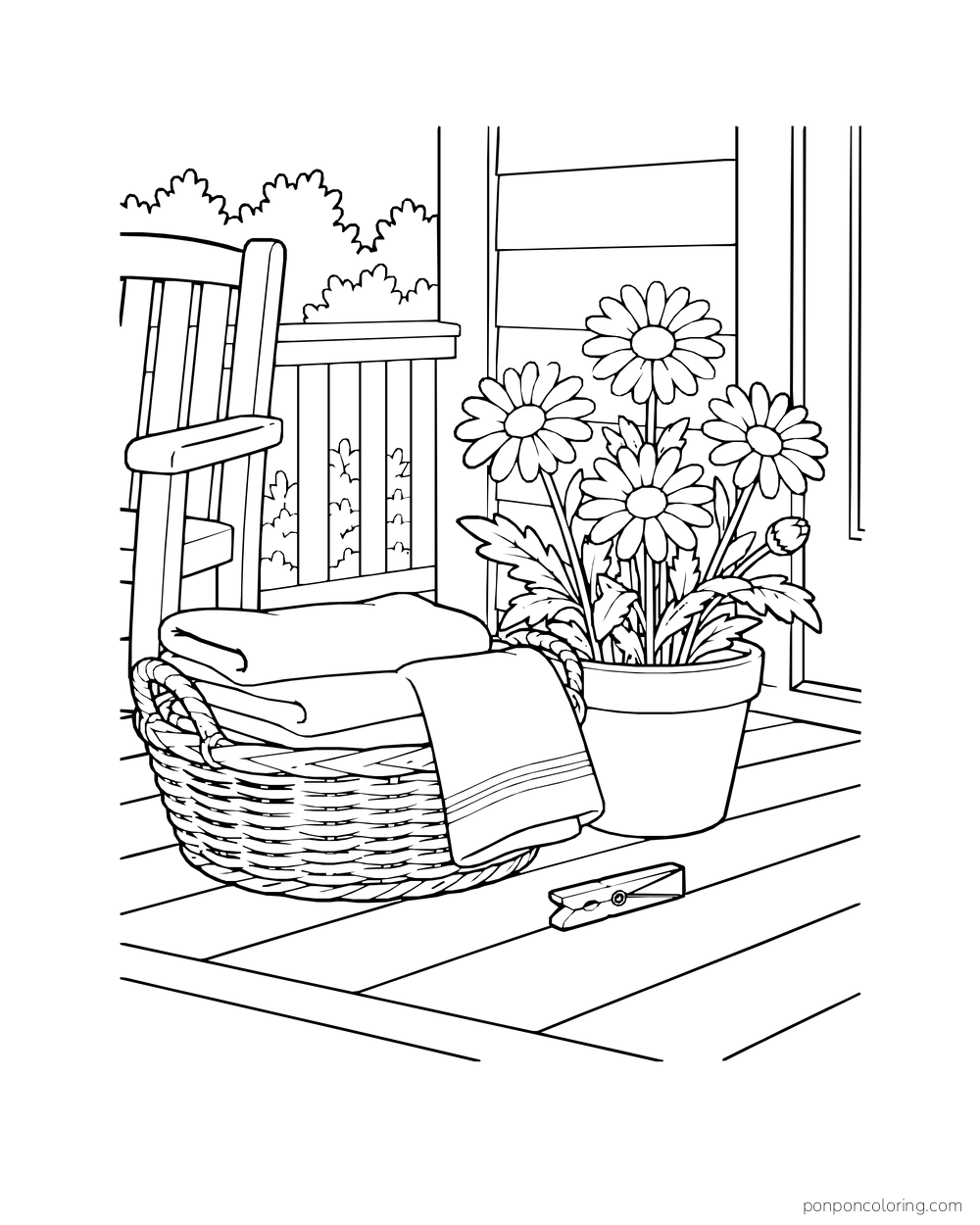 Folded towels fill a basket beside a pot of daisies on a porch.