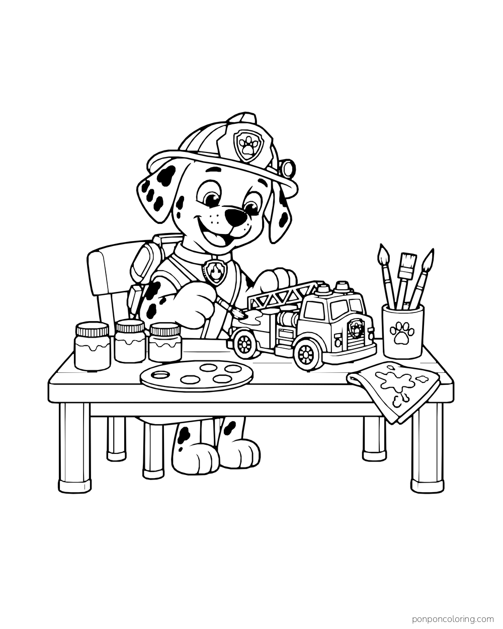 Marshall paints a toy fire truck at a table with paint jars, a palette and a brush cup.