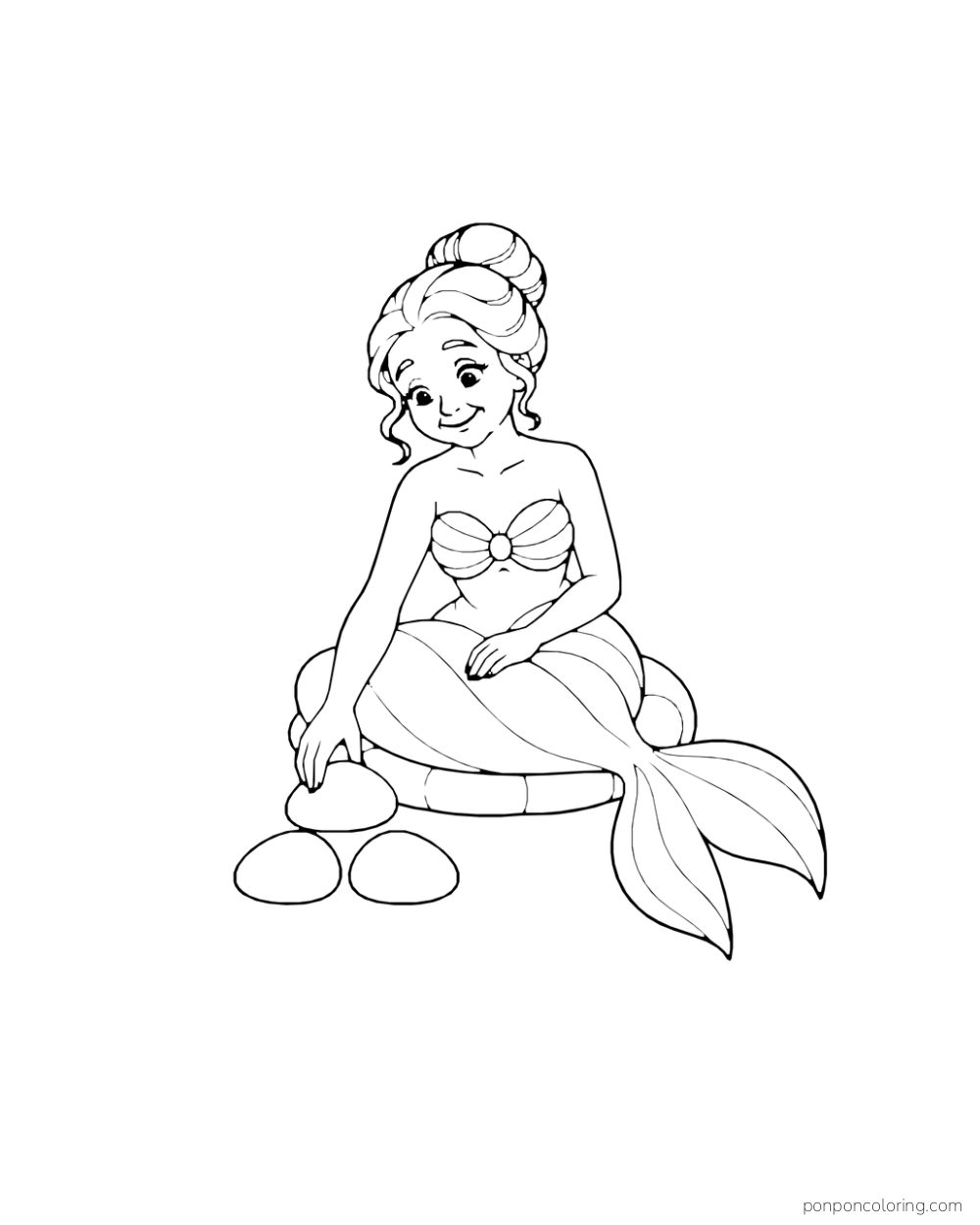 A mermaid places smooth rounded stones together in a small arrangement.