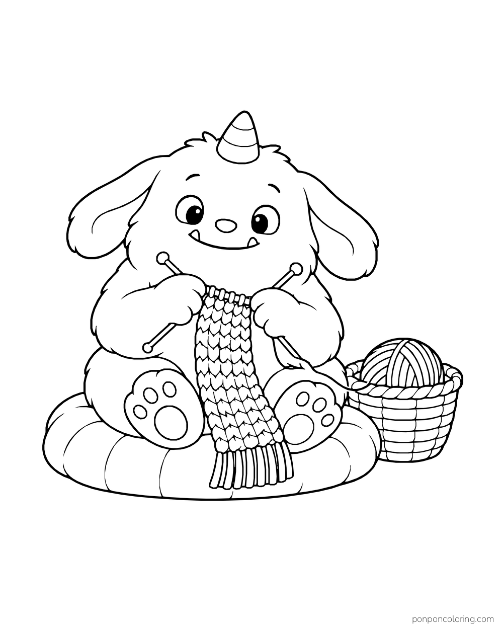 Floppy-eared monster knitting a long scarf on a cushion beside a basket of yarn.