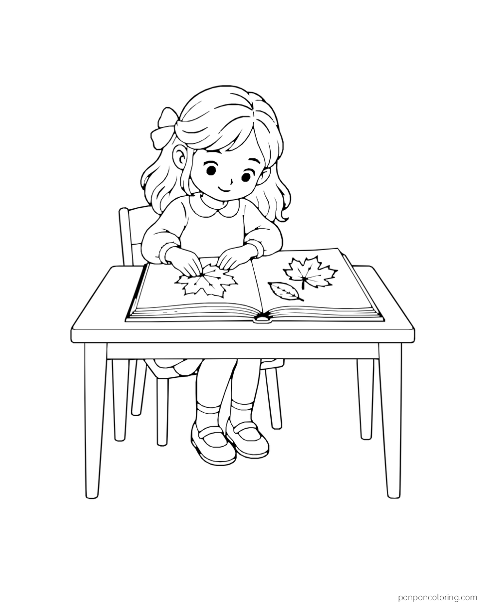 A girl arranges three leaves between the pages of a large book at a table.