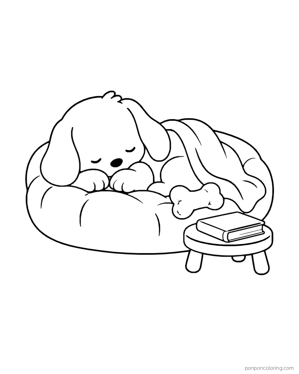 A floppy-eared puppy asleep under a blanket in a round bed, with a plush bone and a book on a small stool.