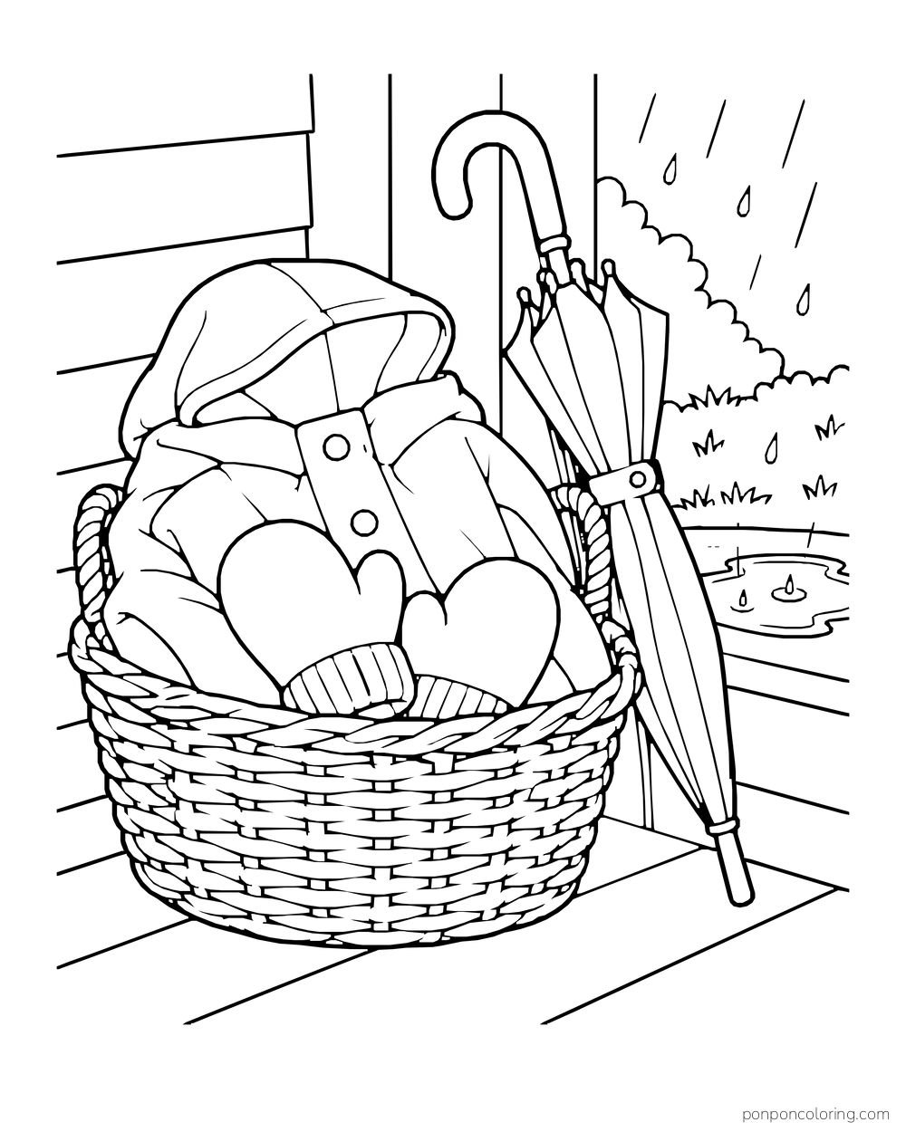 A wicker basket holds folded rain gear beside an umbrella on a porch.