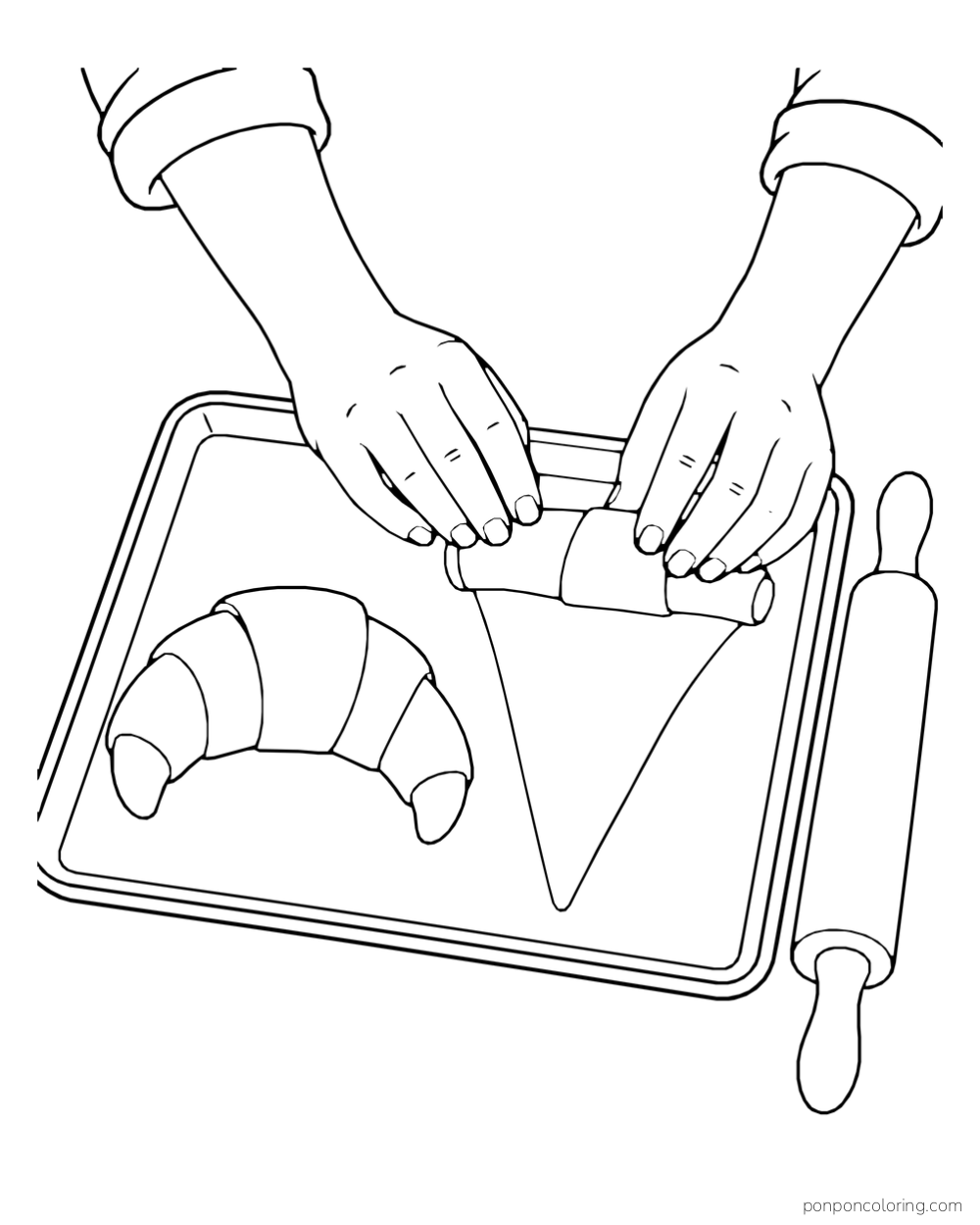 Two hands roll a triangular sheet of dough toward a crescent on a baking tray beside a rolling pin.