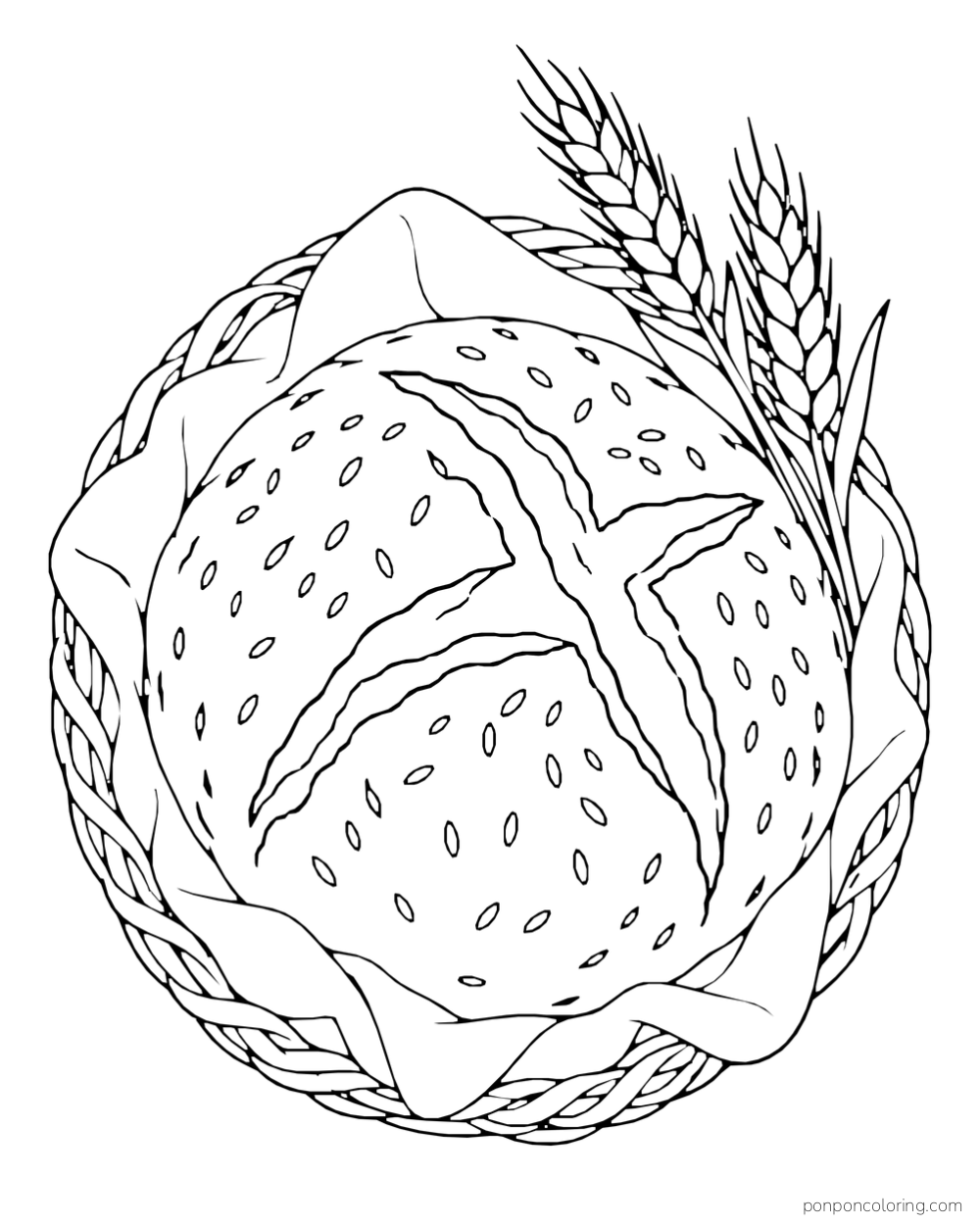 A scored round loaf sits in a woven basket beside two wheat stalks.