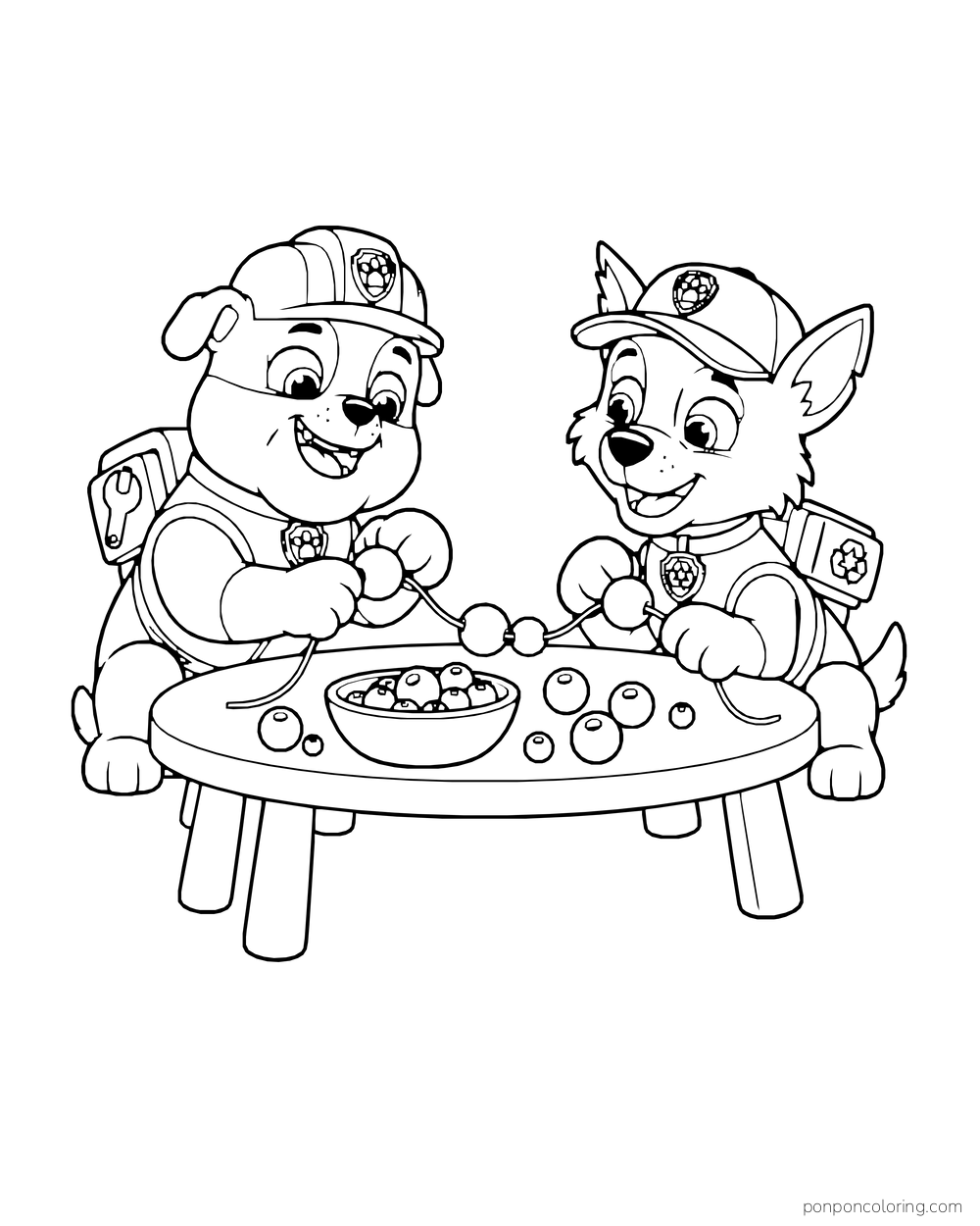 Rubble and Rocky arrange fruit on skewers at a low table.