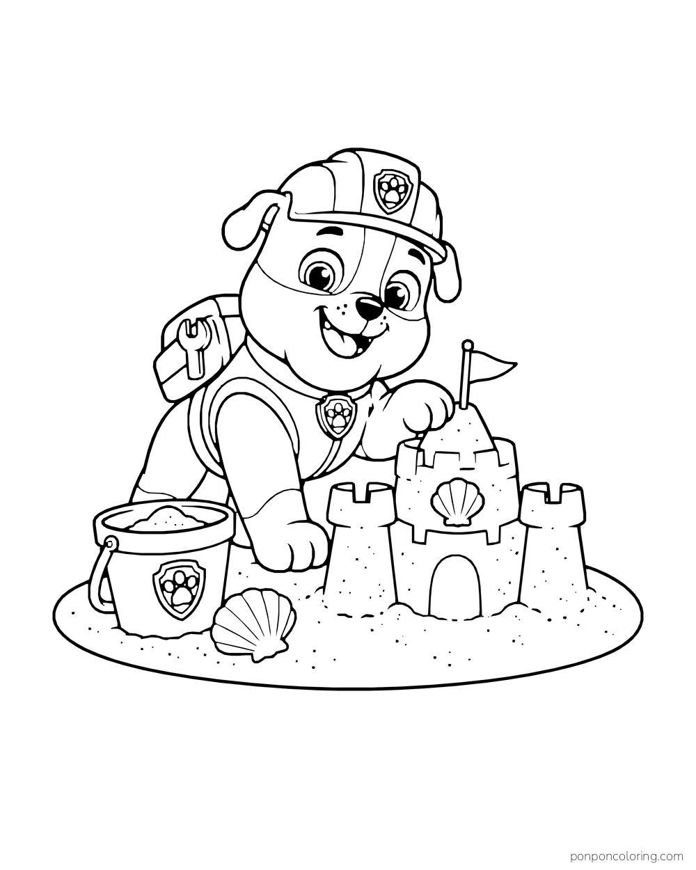 Rubble builds a sandcastle beside a bucket and seashell on an oval patch of sand.