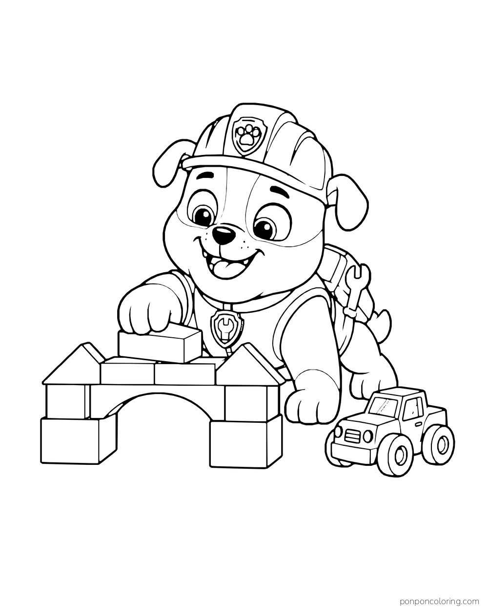 Rubble builds a bridge from toy blocks beside a small toy truck.