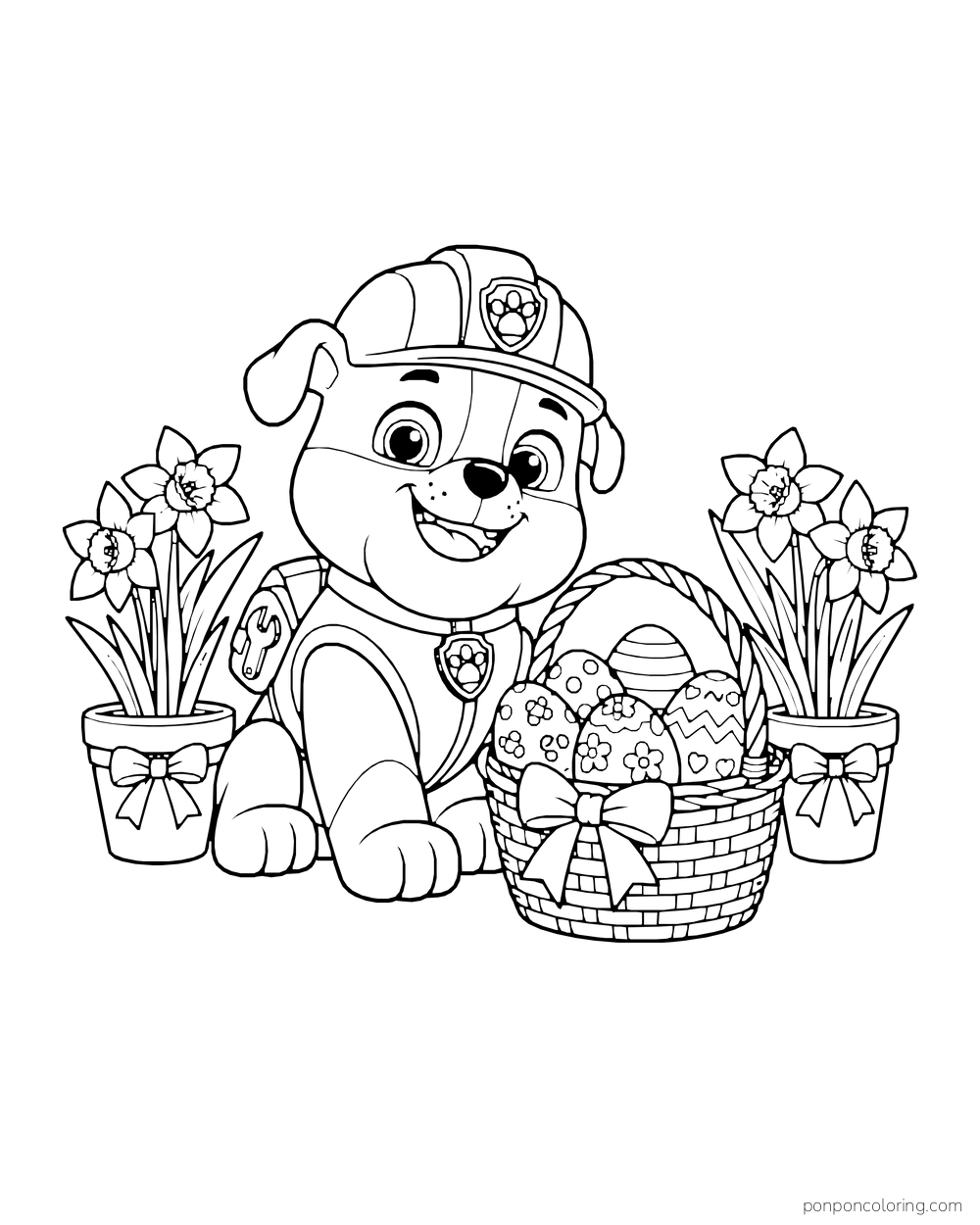 Rubble sits beside a basket of Easter eggs and two pots of daffodils.