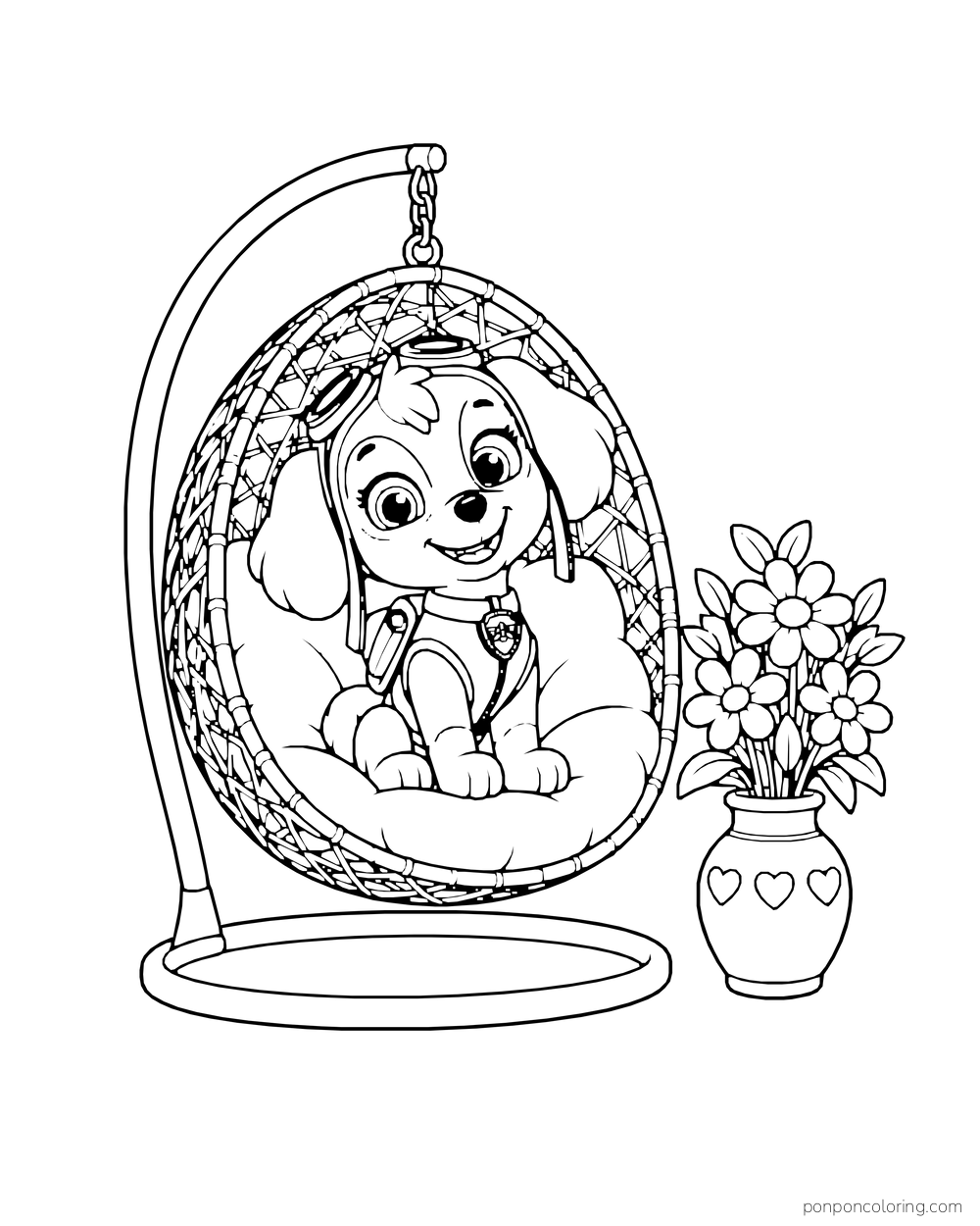 Skye sits in a hanging basket chair beside a vase of flowers.