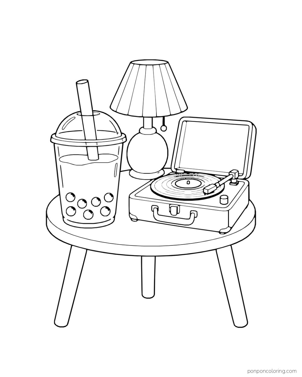A boba cup, table lamp, and open record player sit on a round table.