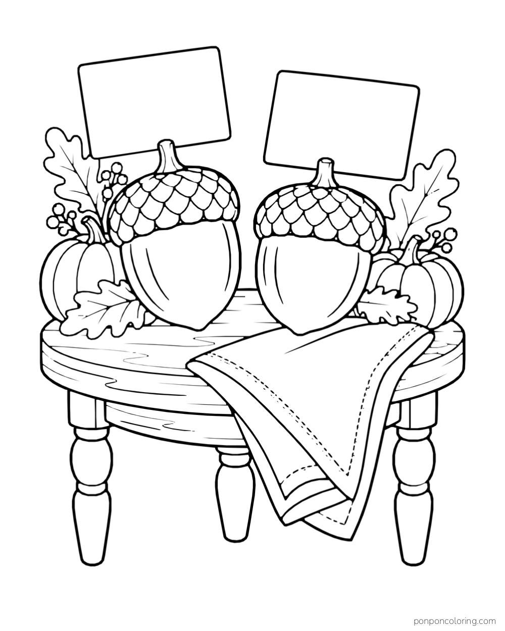 Two acorn holders display blank cards on a round table with a folded napkin and autumn leaves.