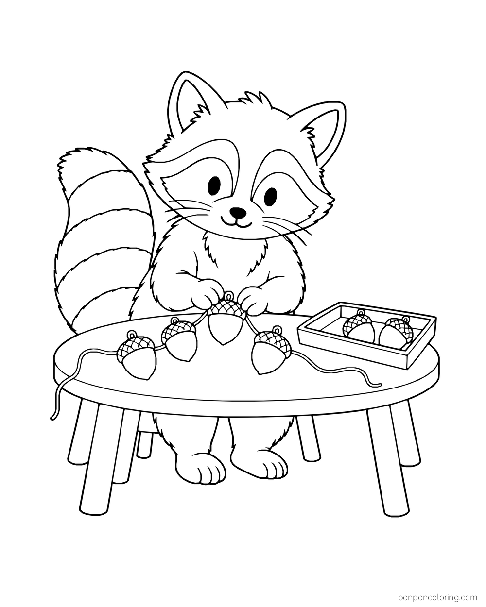 A raccoon threads four acorn ornaments along a string at a table, with two more ornaments in a tray.