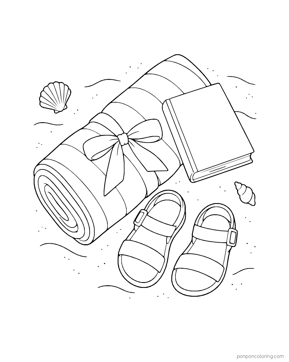 A rolled beach towel, open book, and sandals lie on the sand, seen from above.