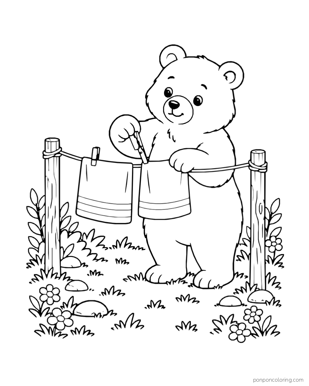 A bear clips two towels to a short clothesline between wooden posts.