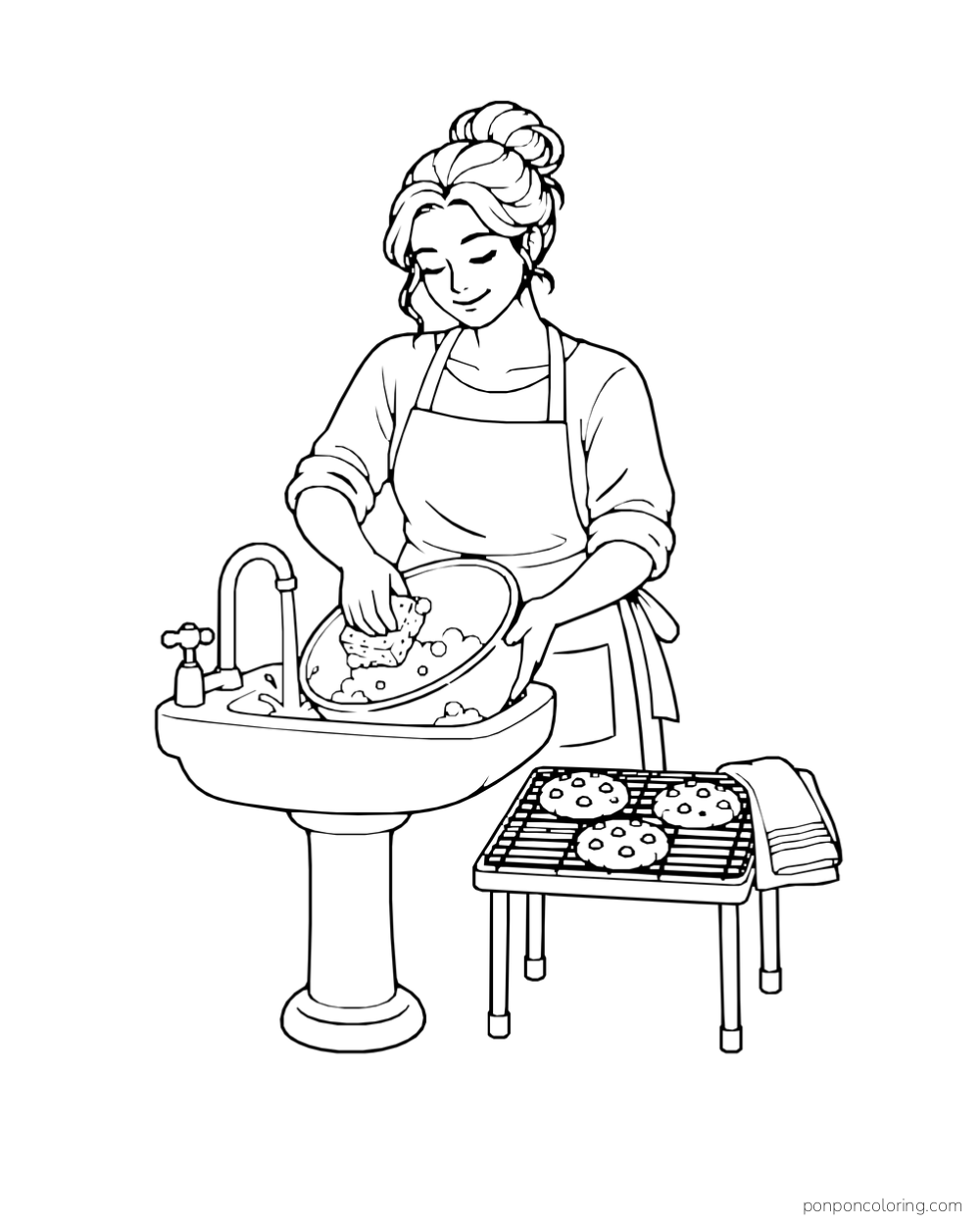A baker washes a mixing bowl at a sink beside a rack of cookies.