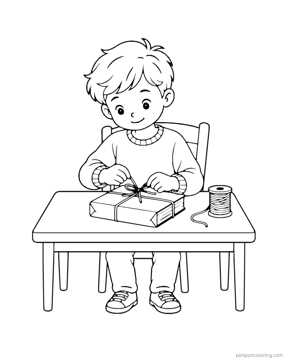 A boy ties string around a wrapped book at a table beside a spool.